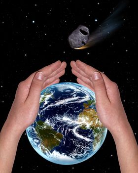 hands covering the planet from a meteorite on the background of stars