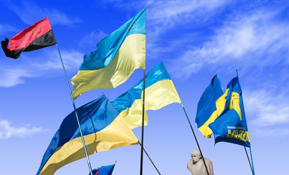 Ukrainian flags on blue sky background