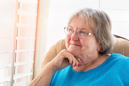 Content Senior Woman Gazing Out of Her Window.