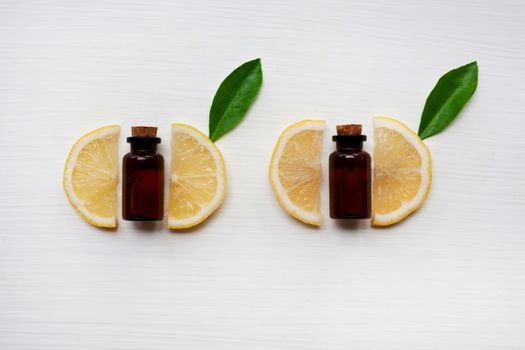 Fresh lemon with lemon essential oil on a white background.