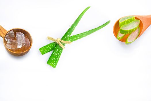 Aloe vera fresh leaves with aloe vera gel on wooden spoon. isolated on white