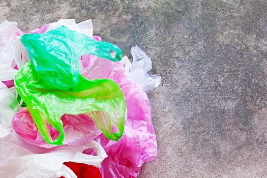 Colorful plastic bag on cement floor background.