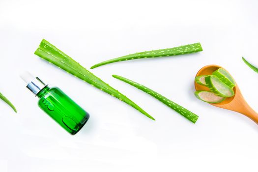 Aloe vera fresh leaves with aloe vera gel on wooden measuring spoon. isolated over white