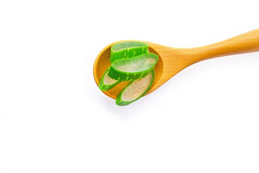 Aloe vera fresh leaves with aloe vera gel on wooden measuring spoon. isolated over white