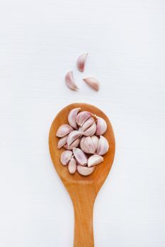 Garlic on white wooden background.