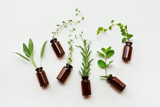 Top view, Bottle of essential oil with herbs