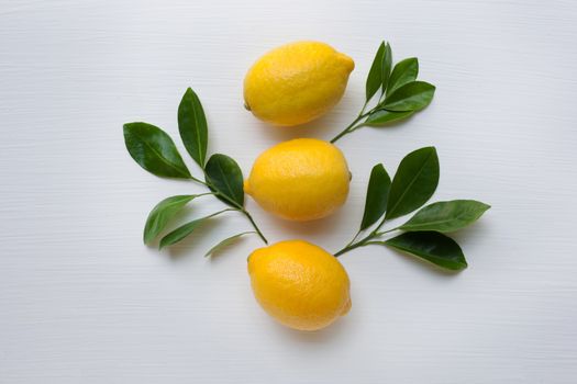 Three yellow lemons on a white background.