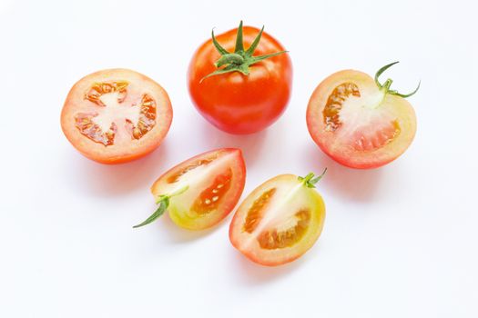 Tomato and pieces of fresh tomato isolated on white background.