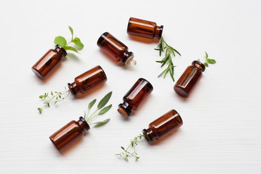Top view, Bottle of essential oil with herbs