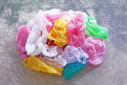 Colorful plastic bag on cement floor background.