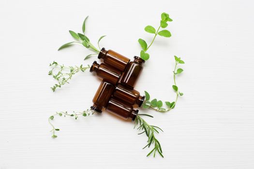 Top view, Bottle of essential oil with herbs