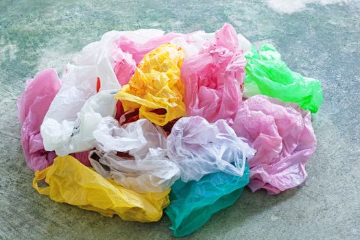 Colorful plastic bag on cement floor background.