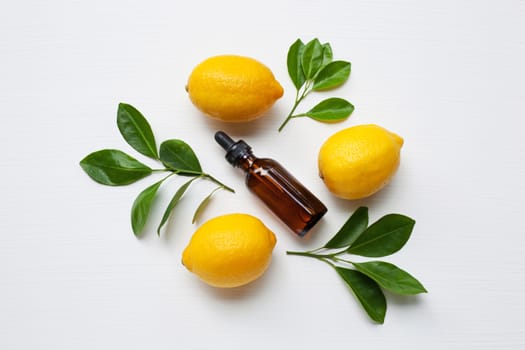 Fresh lemon with lemon essential oil on a white background.