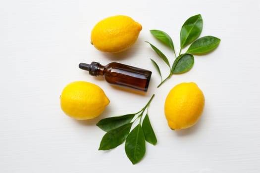 Fresh lemon with lemon essential oil on a white background.