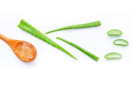 Aloe vera fresh leaves with aloe vera gel on wooden spoon. isolated on white