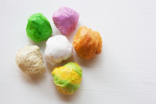 Colorful crumpled plastic bag on white background.