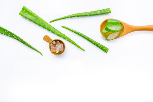 Aloe vera fresh leaves with aloe vera gel on wooden spoon. isolated on white