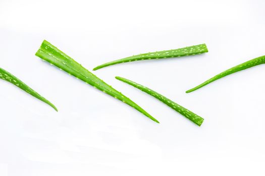 Aloe vera fresh leaves with aloe vera gel on wooden measuring spoon. isolated over white