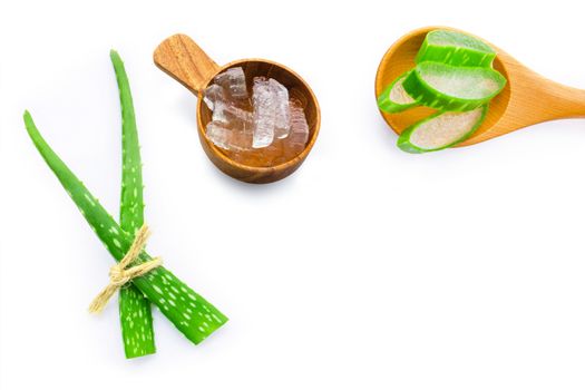 Aloe vera fresh leaves with aloe vera gel on wooden spoon. isolated on white