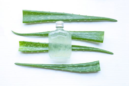 Aloe Vera leaf with bottle of aloe vera juice on white background.