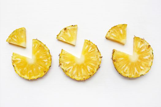 Slices of pineapple isolated on white .