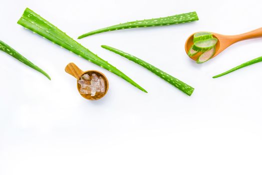 Aloe vera fresh leaves with aloe vera gel on wooden spoon. isolated on white