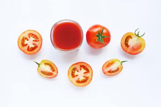 Healthy Drinks. Glass of tomato juice and pieces of fresh tomato isolated on white background.