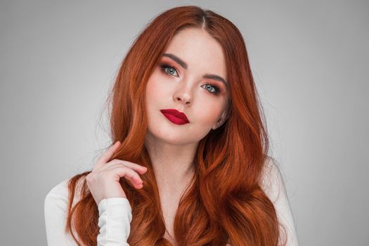 Beauty portrait of woman. Gorgeous sensual attractive pretty redhead sexy model girl, shiny wavy hair.