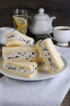 Slices of sandwich with ricotta and black olives