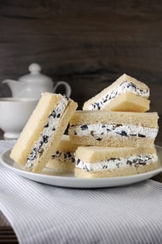 Slices of sandwich with ricotta and black olives