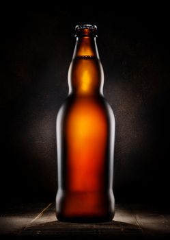 Lager beer in bottle on wooden background