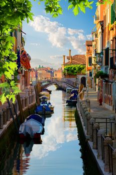 Boats in narrow venetian water canal, Italy