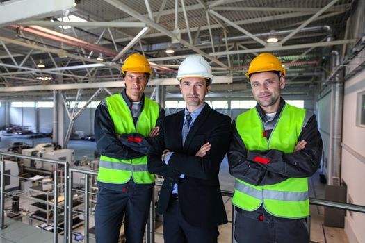 Team of manager and two workers in CNC factory