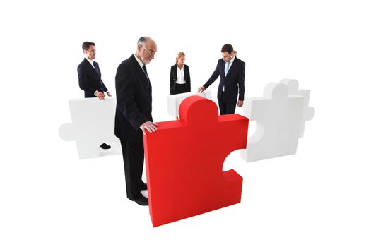 Business team assembling big puzzle isolated on white background