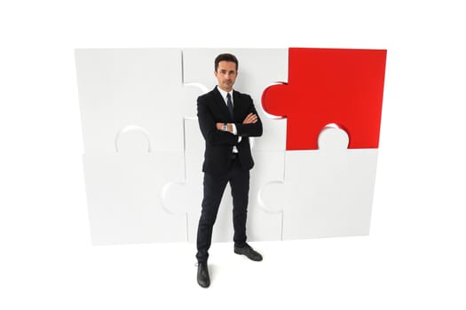 Business man portrait and big puzzle isolated on white background
