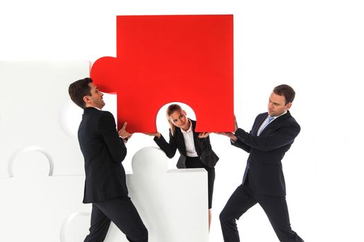 Business team assembling big puzzle isolated on white background