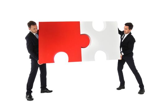 Business men holding two puzzle pieces to connect isolated on white background