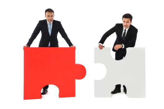 Business men holding two puzzle pieces to connect isolated on white background