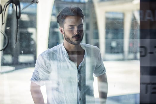 One handsome young man in urban setting in European city