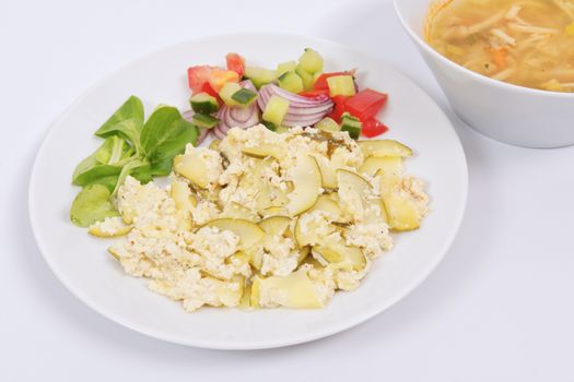 Baked zucchini vegetable salad on a white background