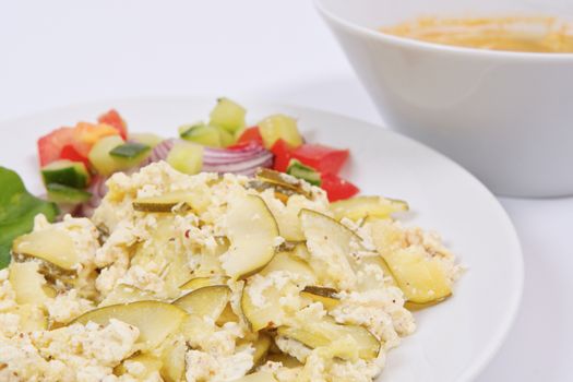 Baked zucchini vegetable salad on a white background