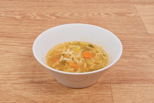 Noodle soup with vegetables on a white background