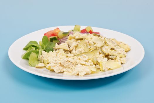 Baked zucchini vegetable salad on a white background