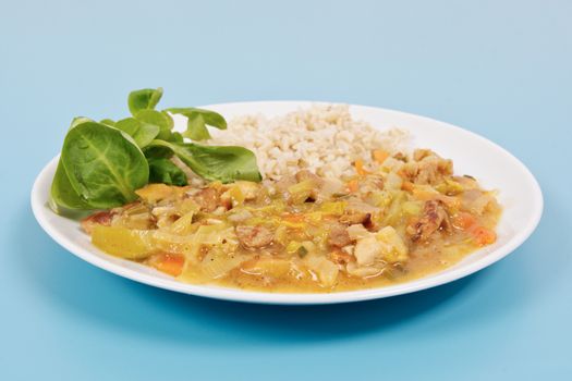 China of soy noodles and leek with rice on a blue background