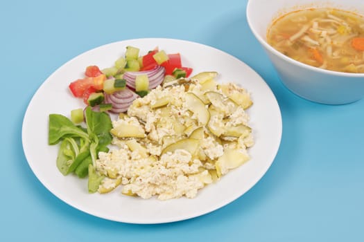 Baked zucchini vegetable salad on a white background