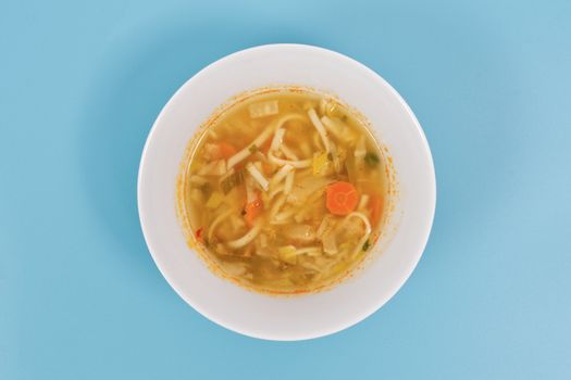 Noodle soup with vegetables on a white background