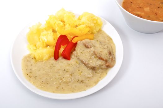 Seitan with dill sauce and potatoes on a white background