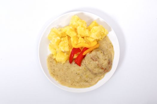 Seitan with dill sauce and potatoes on a white background