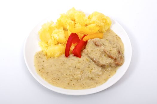 Seitan with dill sauce and potatoes on a white background