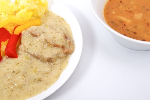 Seitan with dill sauce and potatoes on a white background